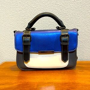 Pixie Mood 7x10x3 blue,white, grey, and black handbag with purple lining.